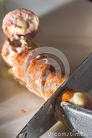 sausage sliced â€‹â€‹on a white board with copy space left, vertical image Stock Photo